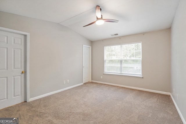 unfurnished bedroom featuring carpet floors, vaulted ceiling, baseboards, and ceiling fan