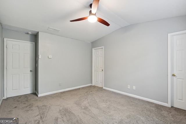 unfurnished bedroom with vaulted ceiling, carpet floors, baseboards, and a ceiling fan