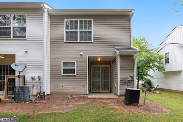 back of house with central AC unit