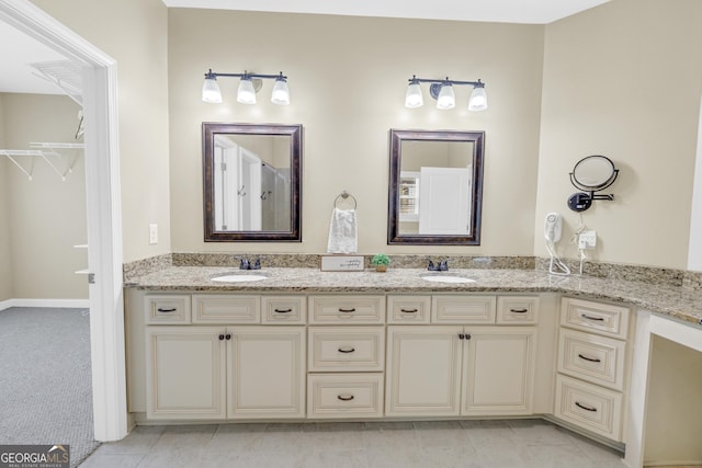 bathroom featuring double vanity and tile patterned flooring