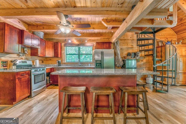 440 Treat Mountain Rd, Cedartown, GA 30125 - kitchen featuring stainless steel appliances, wood ceiling, light wood-type flooring, a breakfast bar, and wooden walls