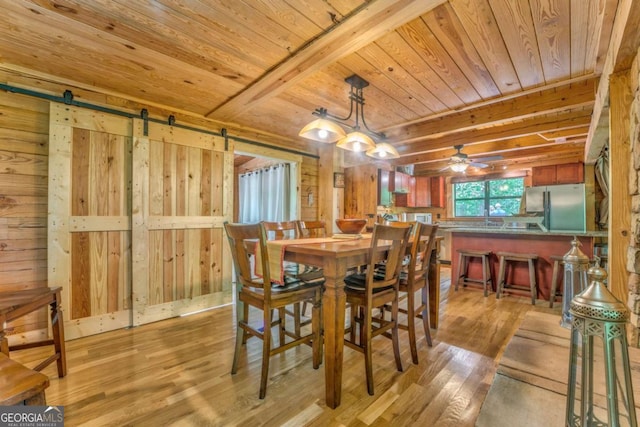 440 Treat Mountain Rd, Cedartown, GA 30125 - dining room featuring wood ceiling, a barn door, light wood finished floors, and wood walls