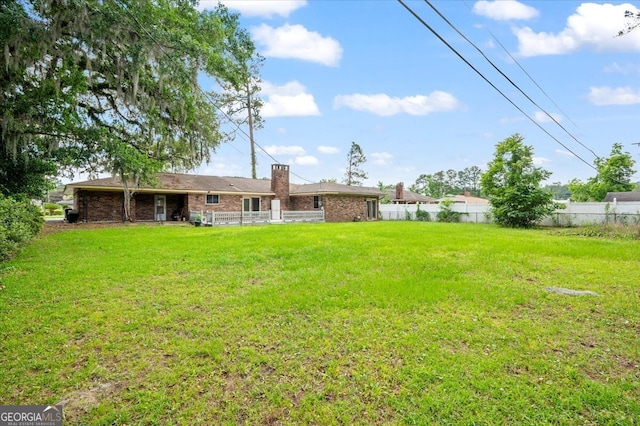 back of property featuring brick siding and a chimney