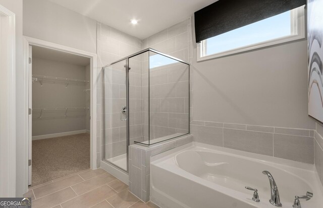 2608 Turnwater St, Hoschton, GA 30548 - bathroom featuring a stall shower, a garden tub, a walk in closet, and tile patterned floors