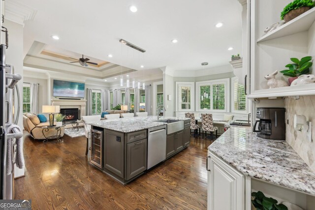 895 Freemanwood Ln, Milton, GA 30004 - kitchen with a warm lit fireplace, a sink, stainless steel dishwasher, ornamental molding, and open floor plan
