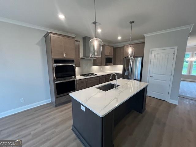 352 Harbour Island Cir, Waverly, GA 31565 - kitchen featuring stainless steel appliances, a sink, wall chimney range hood, light wood-style flooring, and crown molding