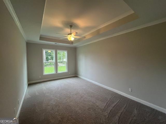 352 Harbour Island Cir, Waverly, GA 31565 - carpeted spare room with a tray ceiling, ceiling fan, baseboards, and ornamental molding