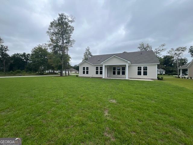 352 Harbour Island Cir, Waverly, GA 31565 - rear view of property featuring a yard