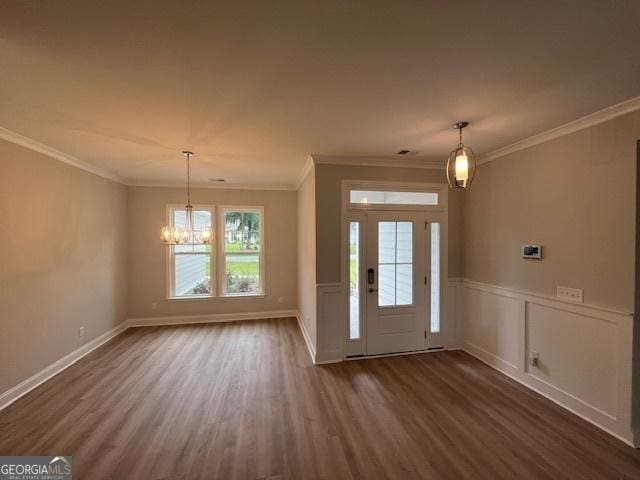 352 Harbour Island Cir, Waverly, GA 31565 - entryway featuring dark wood-style floors, a chandelier, crown molding, wainscoting, and baseboards