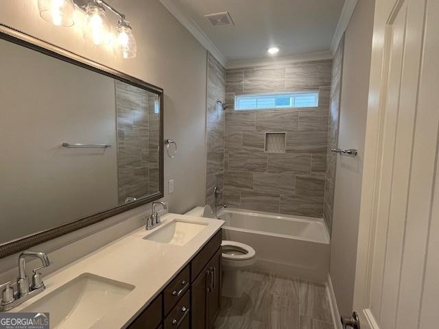 352 Harbour Island Cir, Waverly, GA 31565 - bathroom with toilet, double vanity, ornamental molding, and shower / washtub combination