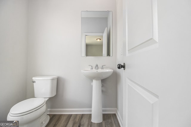 387 Skylar Way SE, Atlanta, GA 30315 - half bathroom featuring wood finished floors, toilet, baseboards, and a sink