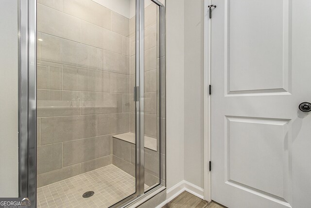 387 Skylar Way SE, Atlanta, GA 30315 - bathroom featuring a shower stall, baseboards, and wood finished floors