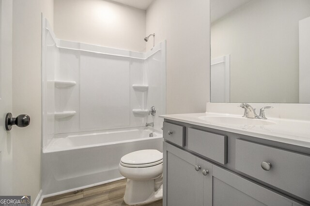 387 Skylar Way SE, Atlanta, GA 30315 - bathroom with wood finished floors, toilet, washtub / shower combination, and vanity