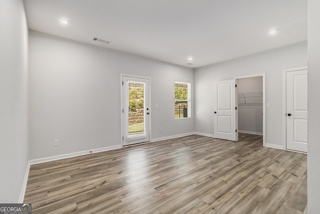 387 Skylar Way SE, Atlanta, GA 30315 - unfurnished bedroom featuring wood finished floors, access to outside, recessed lighting, baseboards, and a spacious closet