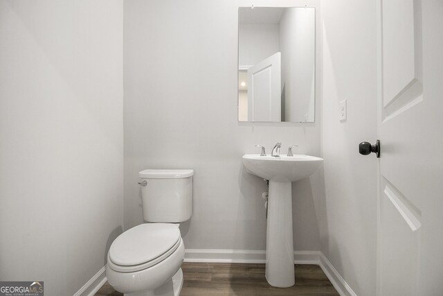 387 Skylar Way SE, Atlanta, GA 30315 - half bathroom with baseboards, wood finished floors, toilet, and a sink