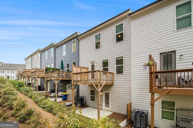 387 Skylar Way SE, Atlanta, GA 30315 - back of property with central AC, a patio area, a residential view, and a wooden deck