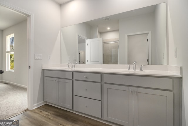 387 Skylar Way SE, Atlanta, GA 30315 - full bathroom with a shower stall, baseboards, double vanity, and wood finished floors