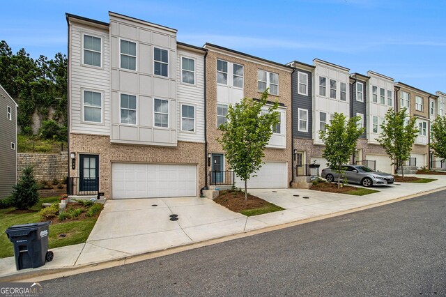387 Skylar Way SE, Atlanta, GA 30315 - multi unit property featuring driveway, a garage, a residential view, and brick siding