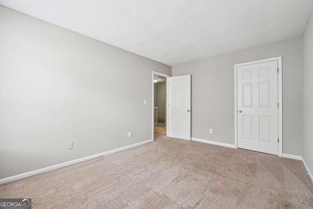 9165 Nesbit Ferry Rd # 9, Alpharetta, GA 30022 - unfurnished bedroom featuring carpet floors and a textured ceiling