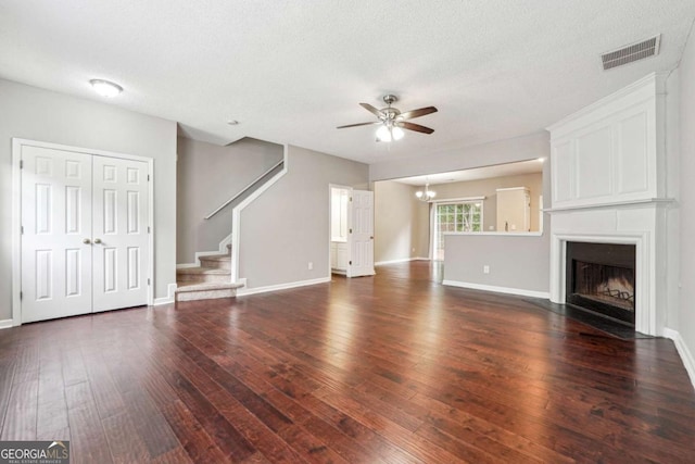 9165 Nesbit Ferry Rd # 9, Alpharetta, GA 30022 - unfurnished living room with ceiling fan, dark wood finished floors, stairway, a fireplace, and a textured ceiling