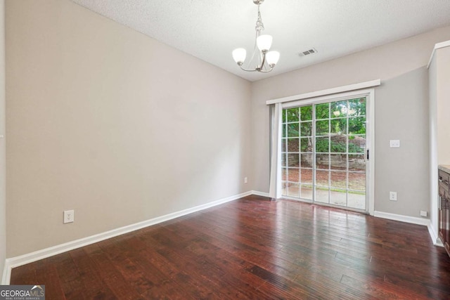 9165 Nesbit Ferry Rd # 9, Alpharetta, GA 30022 - empty room featuring a chandelier and dark wood-type flooring