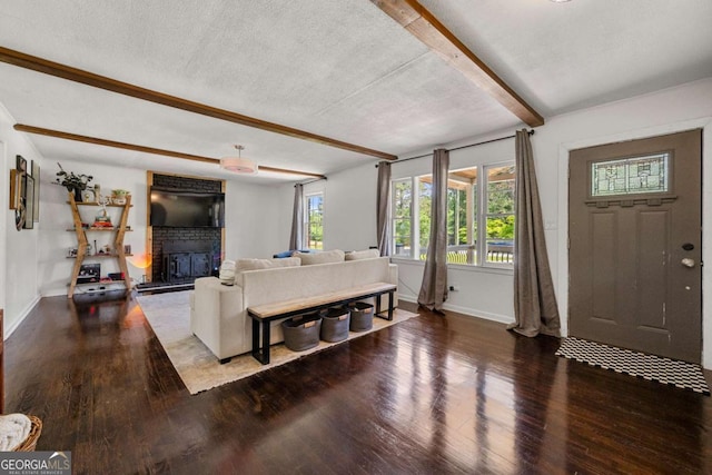 3770 Ponderosa Ln, Powder Springs, GA 30127 - living area with beam ceiling, wood finished floors, a fireplace, baseboards, and a textured ceiling