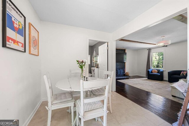 3770 Ponderosa Ln, Powder Springs, GA 30127 - dining space with baseboards, light tile patterned floors, and beam ceiling