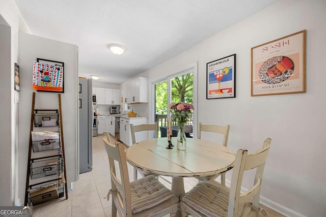 3770 Ponderosa Ln, Powder Springs, GA 30127 - dining room featuring light tile patterned flooring and baseboards