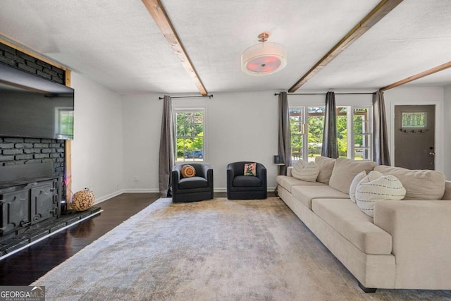 3770 Ponderosa Ln, Powder Springs, GA 30127 - living room featuring beamed ceiling, wood finished floors, a fireplace, and baseboards