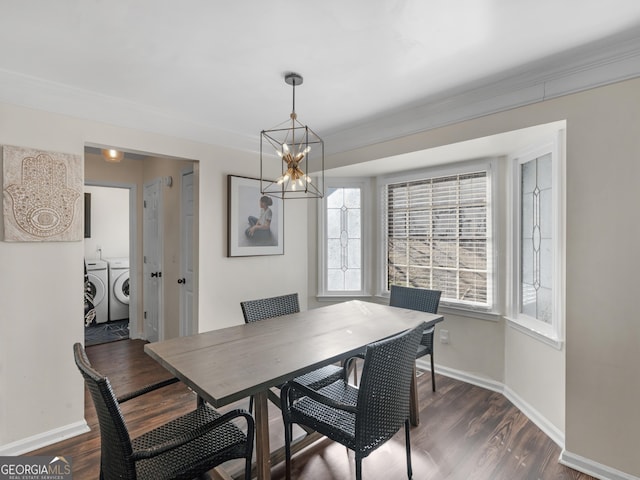 526 Lakeside Dr, Hiram, GA 30141 - dining space with independent washer and dryer, a chandelier, healthy amount of natural light, baseboards, and crown molding