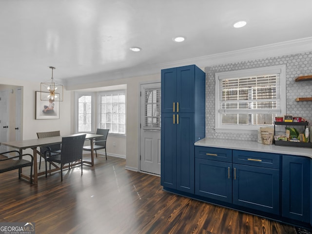 526 Lakeside Dr, Hiram, GA 30141 - kitchen featuring blue cabinets, light countertops, ornamental molding, dark wood-type flooring, and baseboards