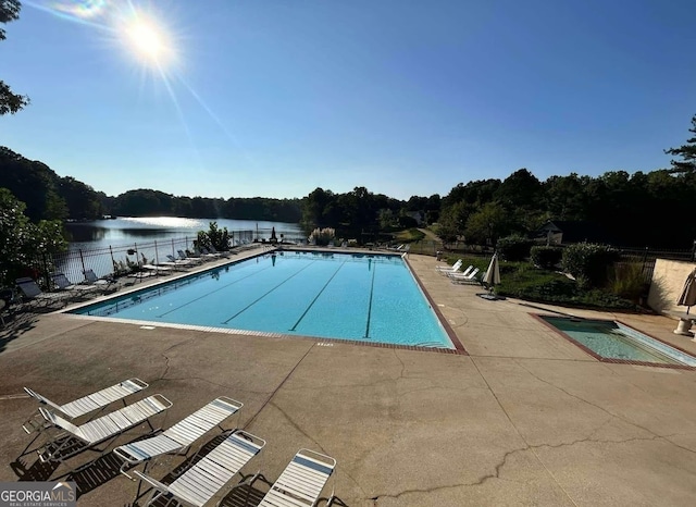 526 Lakeside Dr, Hiram, GA 30141 - community pool with fence, a patio area, a water view, and a wooded view