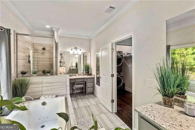 163 Thompson Ln, Jasper, GA 30143 - full bath featuring stacked washer / drying machine, a stall shower, a tub with jets, ornamental molding, and vanity