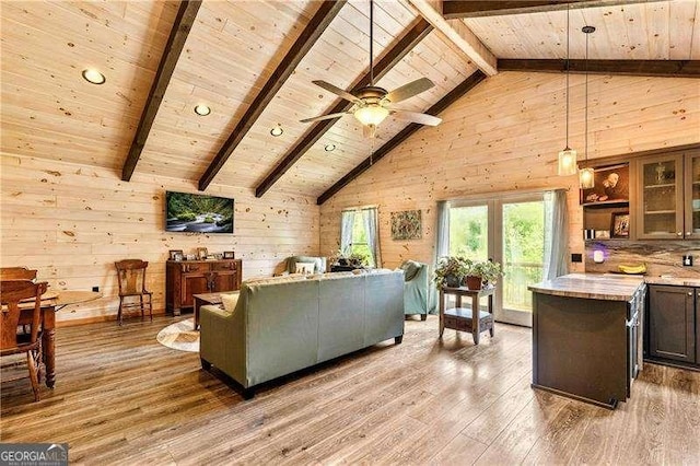 163 Thompson Ln, Jasper, GA 30143 - living area with wood ceiling, beamed ceiling, light wood-style flooring, wood walls, and high vaulted ceiling