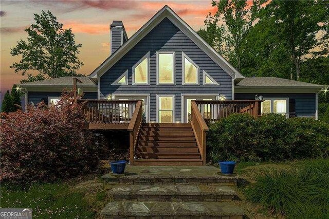 163 Thompson Ln, Jasper, GA 30143 - back of property at dusk with stairs, a deck, and a chimney
