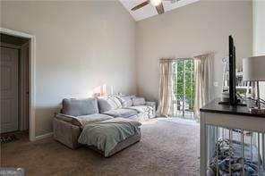 210 Cottonwood Creek Cir, Canton, GA 30114 - living area with a ceiling fan, vaulted ceiling, and carpet