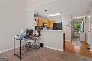 210 Cottonwood Creek Cir, Canton, GA 30114 - kitchen featuring black refrigerator, a peninsula, baseboards, and an office area