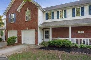 210 Cottonwood Creek Cir, Canton, GA 30114 - view of front of house with a porch, an attached garage, driveway, and brick siding
