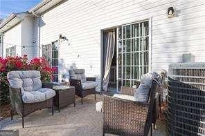 210 Cottonwood Creek Cir, Canton, GA 30114 - view of patio with outdoor lounge area and central AC