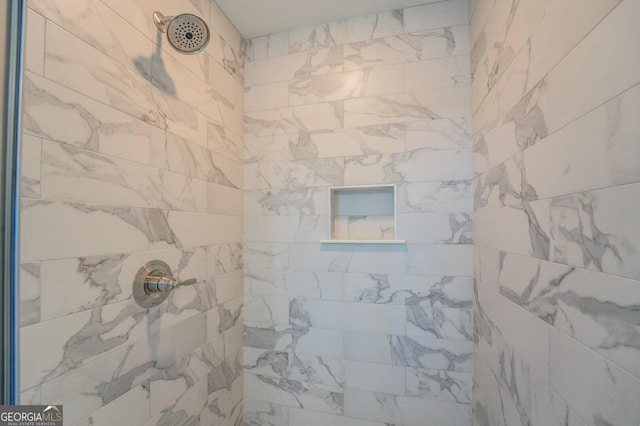 full bathroom featuring tiled shower
