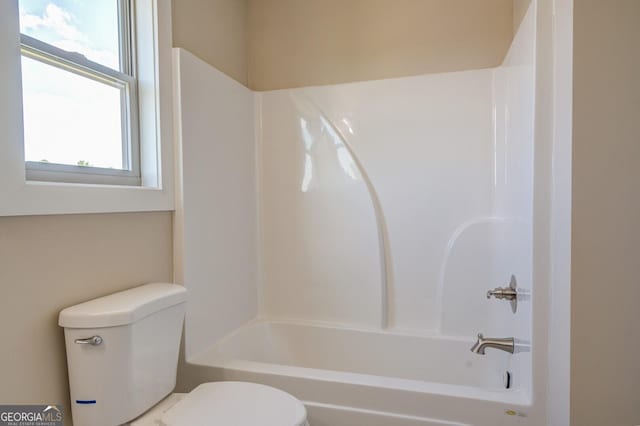 bathroom with toilet and shower / bath combination