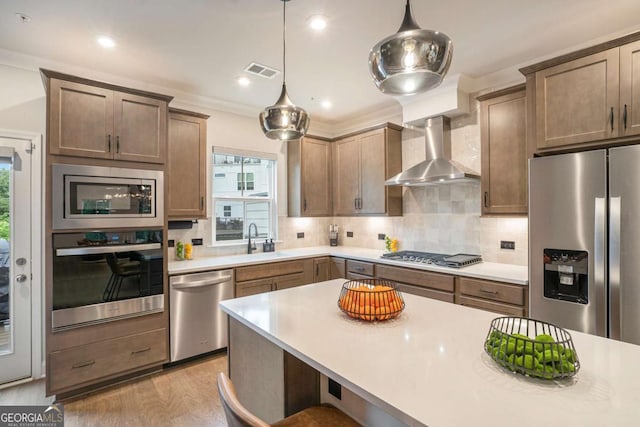 2505 Astaire Ct NW, Atlanta, GA 30318 - kitchen featuring appliances with stainless steel finishes, wall chimney exhaust hood, a sink, light countertops, and decorative backsplash