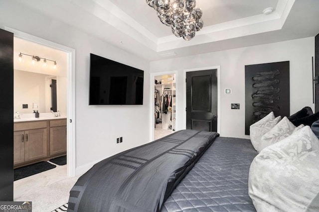 2505 Astaire Ct NW, Atlanta, GA 30318 - bedroom featuring a spacious closet, a raised ceiling, a chandelier, ensuite bath, and a closet