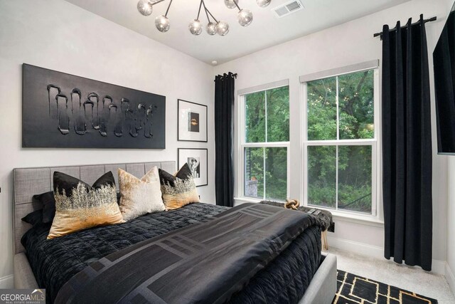 2505 Astaire Ct NW, Atlanta, GA 30318 - carpeted bedroom with a chandelier, multiple windows, and baseboards