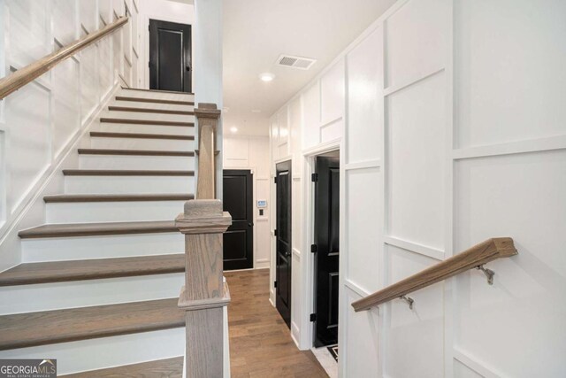 2505 Astaire Ct NW, Atlanta, GA 30318 - staircase featuring wood finished floors and recessed lighting