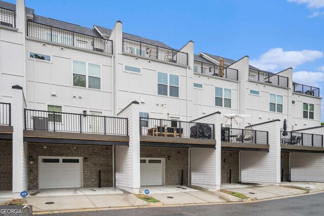 2505 Astaire Ct NW, Atlanta, GA 30318 - view of building exterior with a garage and a residential view