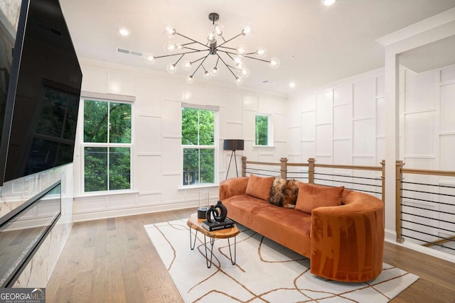 2505 Astaire Ct NW, Atlanta, GA 30318 - living area featuring a chandelier, a decorative wall, light wood-style floors, crown molding, and recessed lighting