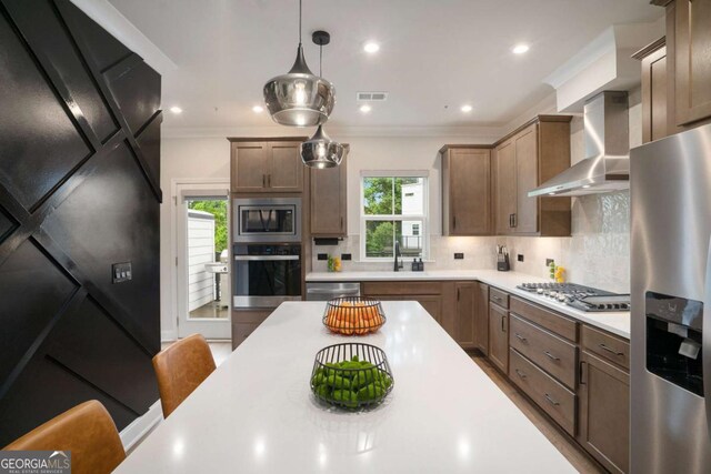 2505 Astaire Ct NW, Atlanta, GA 30318 - kitchen featuring stainless steel appliances, wall chimney range hood, a sink, light countertops, and decorative backsplash