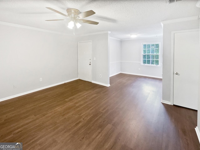 empty room with a ceiling fan, crown molding, dark wood-type flooring, baseboards, and a textured ceiling