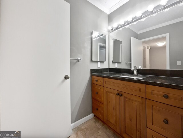 bathroom featuring ornamental molding, baseboards, and vanity